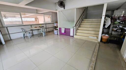 Spacious kitchen area with dining table and stairs