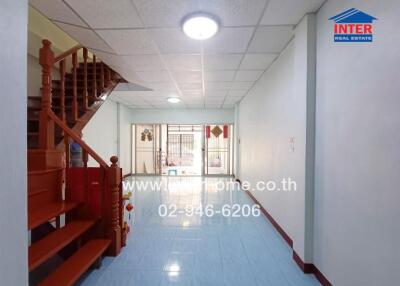 Bright living area with a staircase and tiled floor
