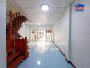 Bright living area with a staircase and tiled floor