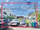 Residential buildings and parked cars under a clear sky