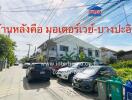 Street view of residential area with houses and parked cars