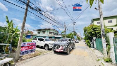 Street view with multiple vehicles and residential buildings