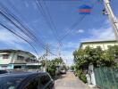 Residential street view with houses and cars