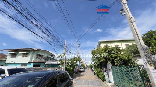 Residential street view with houses and cars