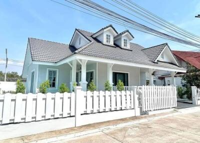 Front view of a house with a white picket fence