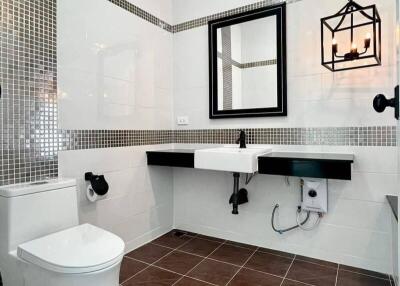 Modern bathroom with white fixtures and black accents