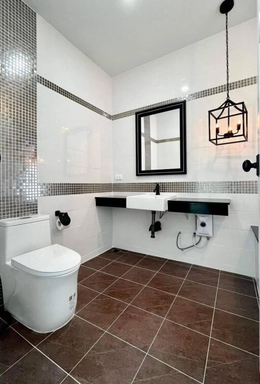 Modern bathroom with white fixtures and black accents