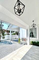 covered outdoor area with lighting and garden view