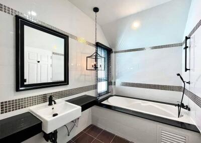 Modern bathroom with a bathtub, sink, and stylish decor