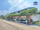 Exterior view of a building with greenery and a paved pathway