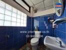 blue-tiled bathroom with glass block window