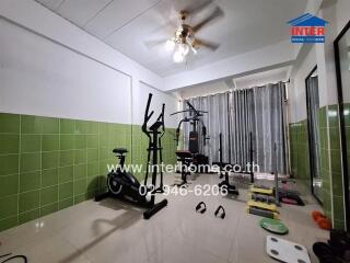 Home gym with equipment and fan