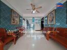 Main entrance hall with wooden benches, blue-tiled walls, and ceiling fan