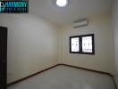 Empty bedroom with window and air conditioner