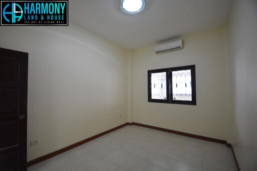 Empty bedroom with window and air conditioner