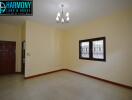 Spacious living room with a light fixture and windows