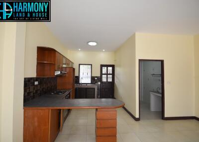 Spacious kitchen with adjacent utility area