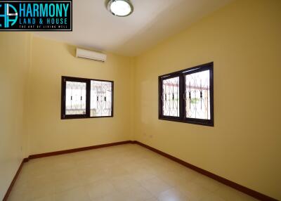 Spacious bedroom with air conditioning and ample natural light