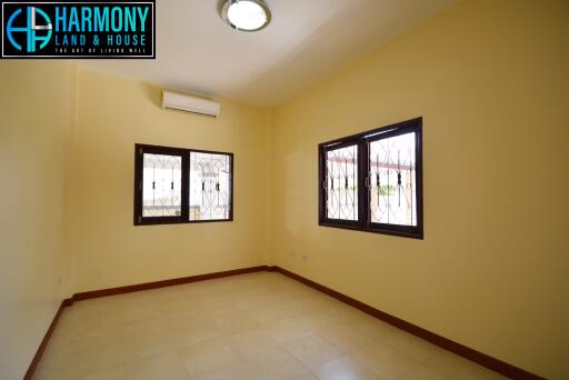 Spacious bedroom with air conditioning and ample natural light