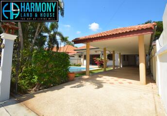 Driveway and front of house with swimming pool