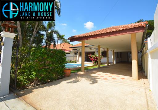 Driveway and front of house with swimming pool