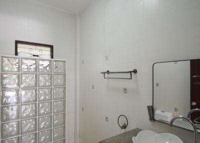 Modern bathroom with glass block partition and vessel sink