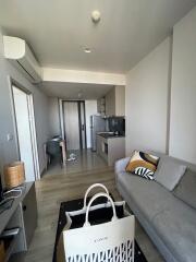 Modern living room with kitchen area and light neutral decor