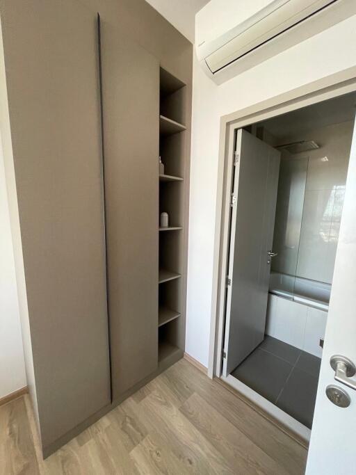 Modern bathroom with storage shelves and wooden flooring