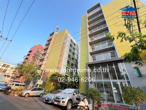 Modern apartment complex with multiple stories and parking area