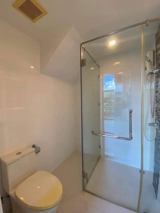 Modern bathroom with glass shower enclosure and toilet