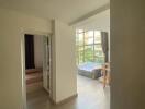 Bright and airy hallway leading to bedroom and living area