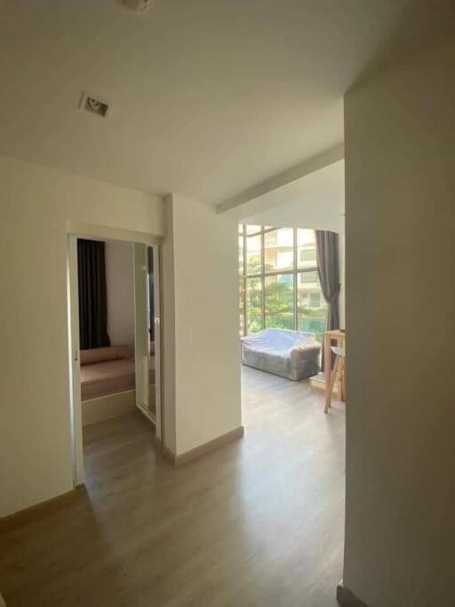 Bright and airy hallway leading to bedroom and living area