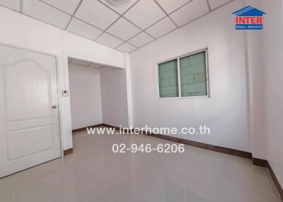 Unfurnished bedroom with tiled floor and window