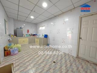 Spacious kitchen with tiled walls and floor