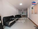 Living room with black sofas and bright lighting