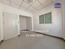 Empty room with tiled floor and white walls featuring a door and window