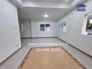 Living room with tiled flooring and large windows