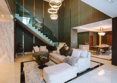 Spacious and modern living room with stairway and dining area