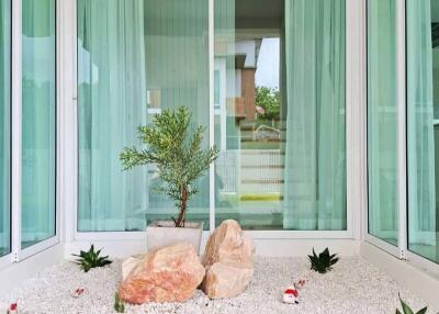 Enclosed patio with greenery and rocks