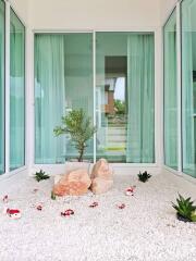 Enclosed patio with greenery and rocks