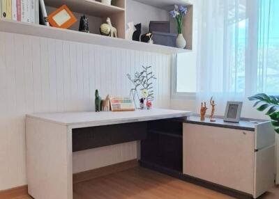 Modern home office with built-in shelving and desk