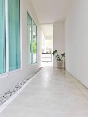 Bright corridor with large window and potted plant