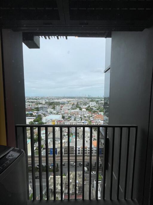 View from a high-rise apartment balcony overlooking the cityscape