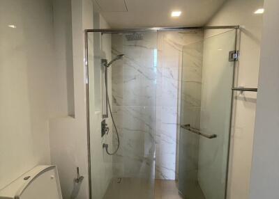 Modern bathroom with glass-enclosed shower and toilet