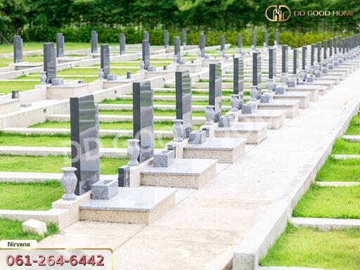 A serene cemetery with well-maintained graves and lush green surroundings