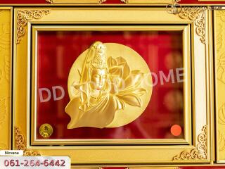 Framed golden artwork depicting a figure with intricate details