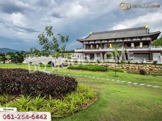 Front view of a large traditional-style house with landscaped garden