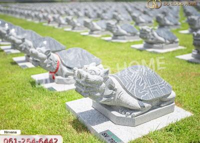 Multiple stone turtle sculptures on grass