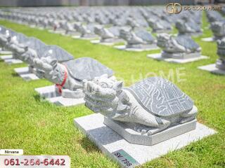 Multiple stone turtle sculptures on grass