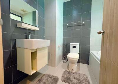 Modern bathroom with sink, toilet, and bathtub